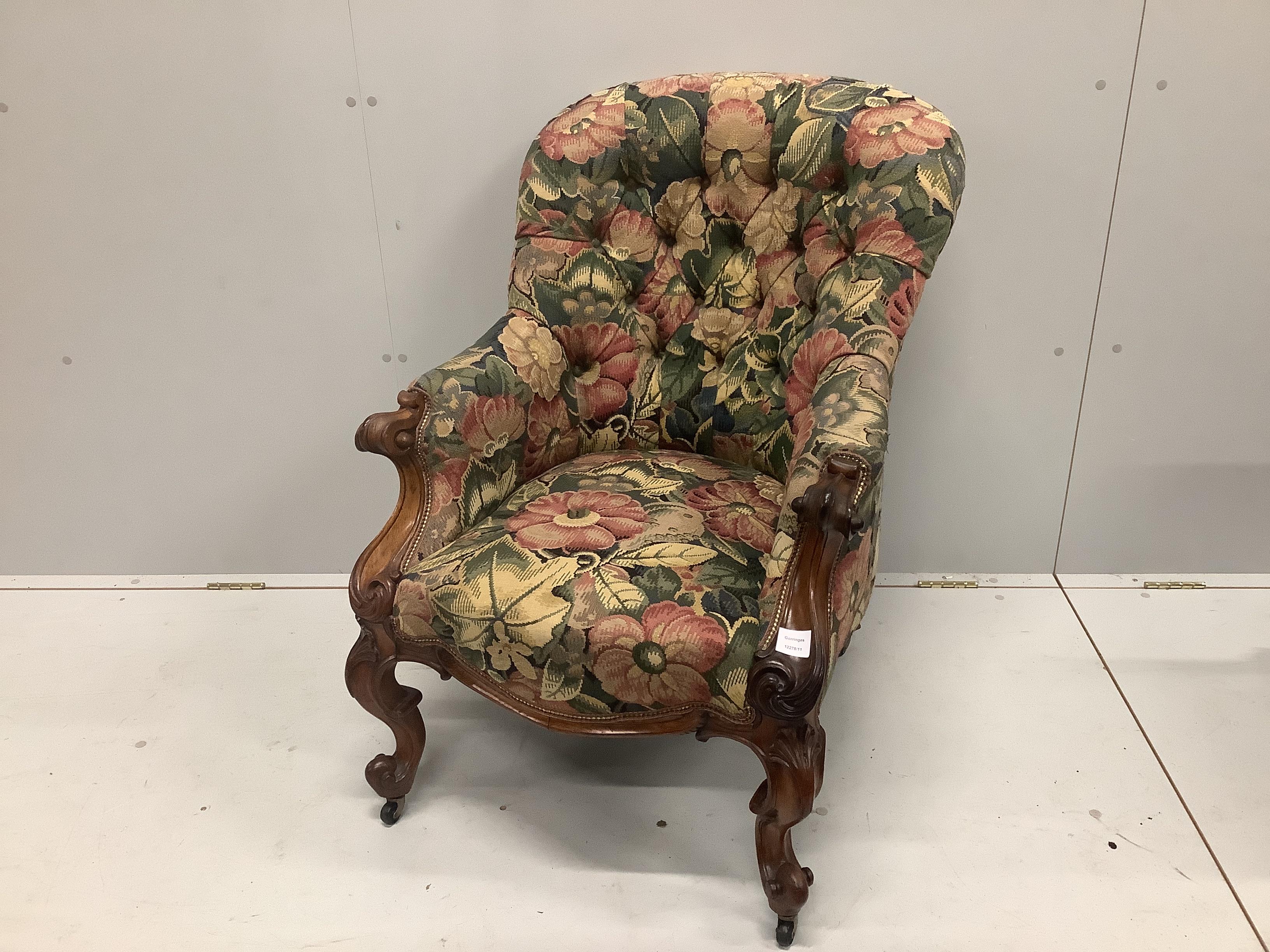 An early Victorian rosewood spoon back armchair with buttoned floral upholstery, width 68cm, depth 78cm, height 91cm